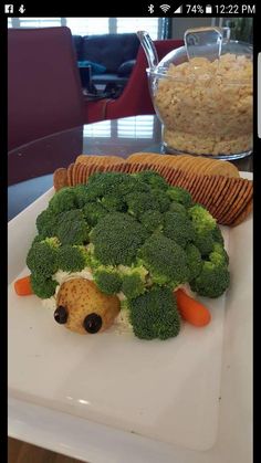 a white plate topped with broccoli on top of a table