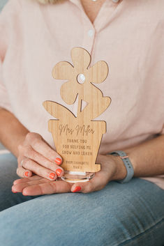 a woman is holding an award for her work on the project, miss mele