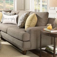 a living room filled with furniture and pillows