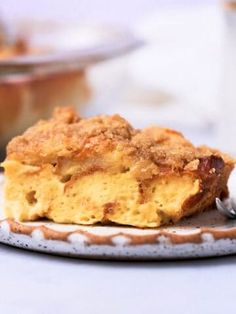 a piece of pie on a plate with a fork in front of some other dishes