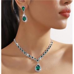 Elevate Your Sophistication With Our 2-Piece Simulated Diamond Teardrop Necklace And Earrings Set, Featuring Striking Emerald Green Lab-Created Crystals. This Elegant Jewelry Set Combines The Timeless Brilliance Of Simulated Diamonds With The Vibrant Allure Of Emerald Green. The Teardrop-Shaped Necklace Gracefully Adorns Your Neckline With Sparkling Simulated Diamonds, While The Emerald Green Lab-Created Crystals Add A Rich And Captivating Touch. Complementing The Necklace, The Matching Earrings Emerald Drop Necklace, Elegant Teardrop Pendant Jewelry Sets For Formal Occasions, Elegant Formal Jewelry Sets With Teardrop Pendant, Elegant Teardrop Pendant Jewelry For Party, Elegant Jewelry Sets With Teardrop Pendant For Party, Green Teardrop Jewelry For Evening, Teardrop Necklace With Matching Earrings For Parties, Green Jewelry Sets For Evening, Party Teardrop Necklace With Matching Earrings