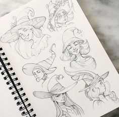 a notebook with drawings of witches on it and a pencil in front of the pages