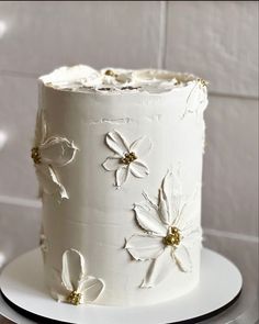 there is a white cake with flowers on it