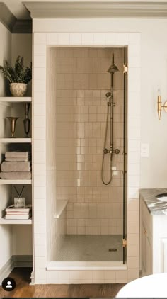 a walk in shower sitting inside of a bathroom