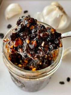 a spoon full of food sitting on top of a table