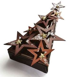 a wooden box filled with stars on top of a white surface