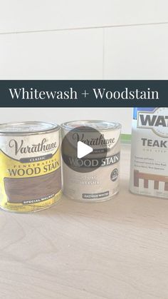 three paint cans sitting on top of a wooden table with the words whitewash and woodstain