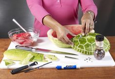 a woman cutting up some food on top of a table