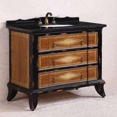 an old fashioned bathroom vanity with black marble top and wooden drawers on the bottom shelf