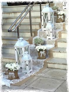 some white lanterns are sitting on the steps