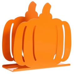 an orange paper holder with two pumpkins on it's sides and one in the middle