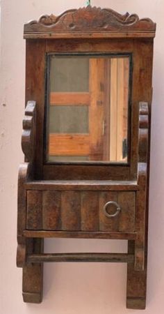 an old wooden dresser with a mirror on it