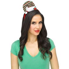 a woman with long black hair wearing a green shirt and a santa hat on her head