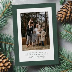 a christmas card with an image of three children and pine cones