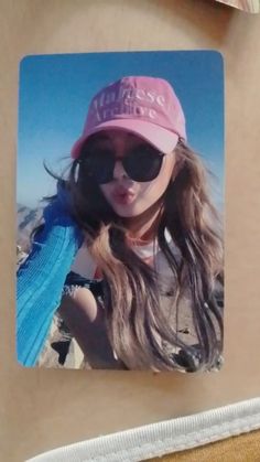 a girl with sunglasses and a pink hat