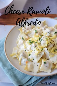 a white plate topped with ravioli and cheese