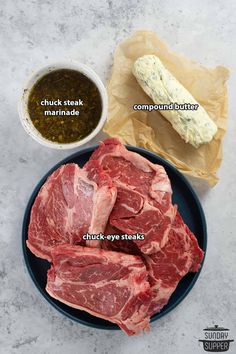 raw meat on a plate with spices and seasoning next to it, including steak marinade