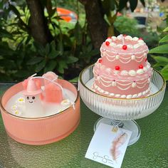 two cakes sitting on top of a table next to each other