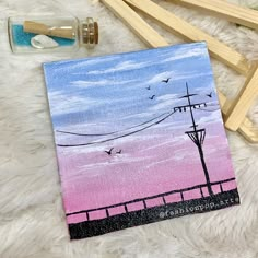 an acrylic painting of a pink and blue sky with power lines in the background