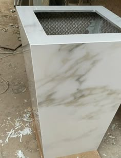 a white marble counter top sitting on top of a wooden pallet