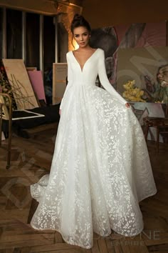 a woman in a white wedding dress posing for the camera