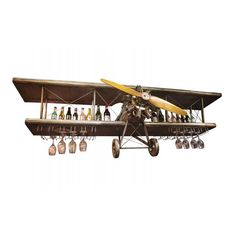 an old fashioned airplane with wine bottles hanging from it's wings