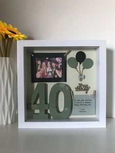 a white frame with the number forty four in front of it and a yellow flower