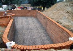 a construction site with bricks and cement in the ground