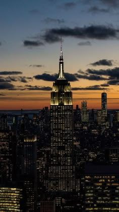 the empire building lit up at night in new york city