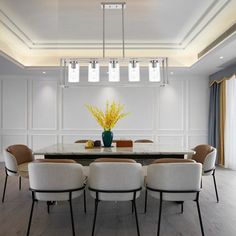 a dining room table with chairs and a vase filled with yellow flowers on top of it