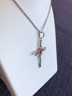 "This cross displays a beautiful piece of Red Coral in the middle of a wavy cross. The cross is about 2.5\" and 1.5\" in width. The chain is 18\" Please let us know if you have any questions!" Metal Crucifix Cross Necklace As Gift, Metal Crucifix Cross Necklace Gift, Metal Crucifix Cross Necklace For Gift, Spiritual Metal Cross Necklace, Metal Cross Necklace With Adjustable Chain, Adjustable Chain Metal Cross Necklace, Gothic Cross Necklace With Adjustable Chain, Handmade Red Cross Pendant Jewelry, Red Spiritual Cross Pendant Jewelry