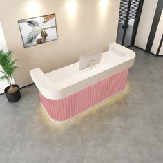 an office with a pink and white reception desk next to a potted palm tree