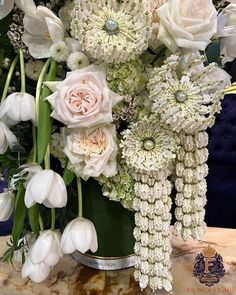 a vase filled with white flowers on top of a table