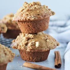 three muffins stacked on top of each other with cinnamon sticks next to them