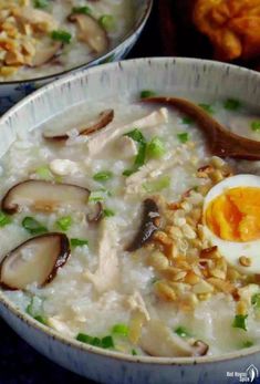 two bowls filled with rice and meat topped with an egg