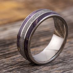 a wedding ring with purple and silver inlays