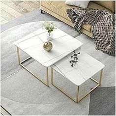 two tables sitting on top of each other in front of a couch and coffee table