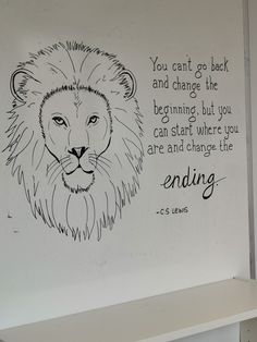 a drawing of a lion is on the wall next to a sign that says you can't go back and change the beginning, but you can start where you are and change the ending