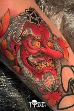 an old man with a red mask on his face is shown in this tattoo design