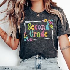 Whether you're looking for a fun and unique gift for a teacher friend or want to treat yourself to something special for the first day of school, this 2nd Grade Teacher shirt is sure to bring a smile to your face and to your students'. Find more back to school shirts, sweatshirts and gifts for your favorite Second Grade Teacher here: https://www.etsy.com/shop/JaxGraphicTees?search_query=second All of our adult t-shirts are Bella + Canvas 3001 Unisex shirts. They are a super soft fabric that will Teacher Shirt Ideas Vinyl, Multicolor Letter Print Tops For School Events, Trendy Multicolor School Shirt, Casual Tops For Birthday And Back To School, Fun Multicolor Shirt For End Of School Year, Fun Back To School Shirt With Letter Print, Funny Multicolor Tops For School, Graphic Print Tops For Birthday And Back To School, Fun Letter Print Shirt For Back To School