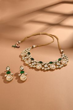 Exude timeless charm with this classic and elegant kundan set, adorned with captivating emerald stones and finished in gold-plated metal. Perfect for adding a touch of sophistication to any ensemble, this set is a timeless addition to your collection. Finish: 22KT Gold Plating Material: Brass, Kundan, Emerald Color: Gold, White & Green Size: Free Size, Adjustable Closure Type: Draw String Box Contains: 1 Necklace, 1 Pair Earrings Hand Jewelry Rings, Chain Braid, Jewellery Photography, Emerald Color, Jewelry Photography, Emerald Stone, Hand Jewelry, Anklet Jewelry, Charm Gift