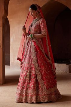 a woman in a red and gold bridal gown