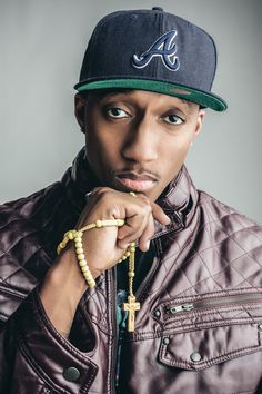 a man wearing a baseball cap and beaded bracelet