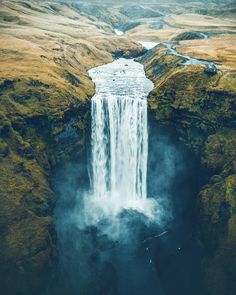 an aerial view of a waterfall in iceland