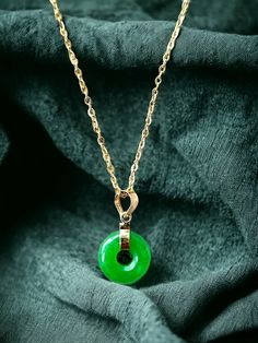 An 10mm, petite 'xiao' version of our classical Jade Disc Pendant. Perfect as a statement piece; we use a simple Jadeite Donut with a gold hook to finish the simple yet elegant look. This evergreen design pairs well in formal and everyday settings alike. The green Jade with the centric hole allows light to pass through creating a focused optical effect. (Gold chain not included) Stock ID: 1JXDP14Y Materials: 0.25g 14K Gold, 1.25g Jadeite Dimensions: 18 x 10 x 3 mm Gross Weight: 1.50g Jade Ring, Disc Pendant, Unique Pendant, Jade Pendant, Green Jade, Jade Green, Pretty Jewellery, Pendant Necklaces, Gold Chain