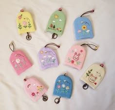 six small purses with embroidered designs on them