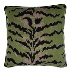 a green and black pillow with an animal print pattern on the front, sitting against a white background