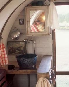 the inside of an airplane cabin with a sink and mirror on the wall next to it