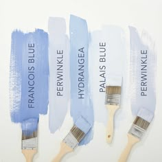 three paintbrushes with different shades of blue on them and the names of each one