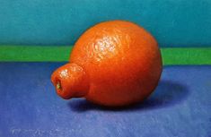 an orange sitting on top of a blue table next to a green and blue wall